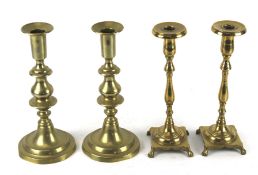 Two pairs of 20th century brass candlesticks. Mounted on circular bases. Max.