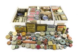 A collection of small vintage product advertising tins.