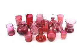 Collection of assorted cranberry glass items.