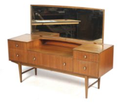 A mid-century retro teak dressing table with mirror. With five drawers, on square tapering supports.