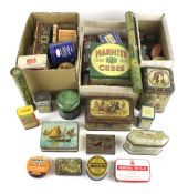 A collection of assorted small vintage product advertising tins.