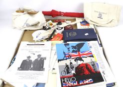 A collection of QEII Cunard related items. Including magazines, an umbrella, postcards, etc.