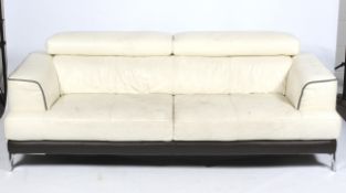 A contemporary cream leather three seater sofa.