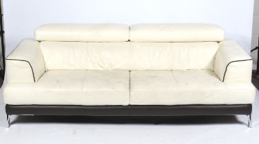 A contemporary cream leather three seater sofa.