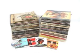 A collection of vinyl records. Including Status Quo, Genesis, Elvis Presley, etc.