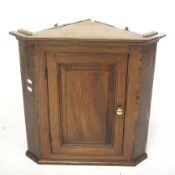 An oak corner cupboard.