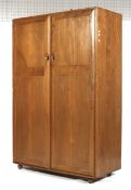 A mid-century Ercol oak wardrobe (blue & gold label). With two doors and on castors.