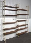 A mid-century Ladderax teak and metal shelving system.