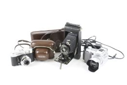 Three vintage cameras. Comprising a digital Minolta Dinage 5 with charge lead, 7.2-50.