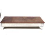 A very large leather faced aluminium coffee table.