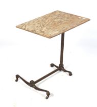 A vintage adjustable and tilt top overbed table. Cast metal base with ball and claw feet.