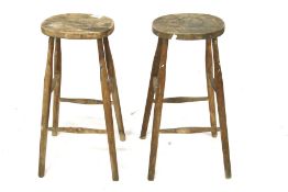 A pair of bar stools with oval seats.