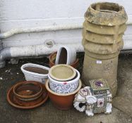 An assortment of garden pots and a chimney flute.