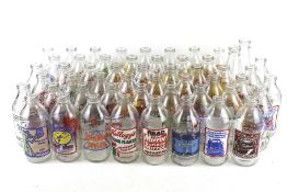 A collection of fifty-three assorted vintage advertising milk bottles. Mostly Unigate 568ml. Max.