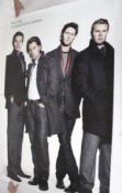 A life-size Take That advertising poster.