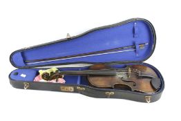 A vintage violin, bow and case.