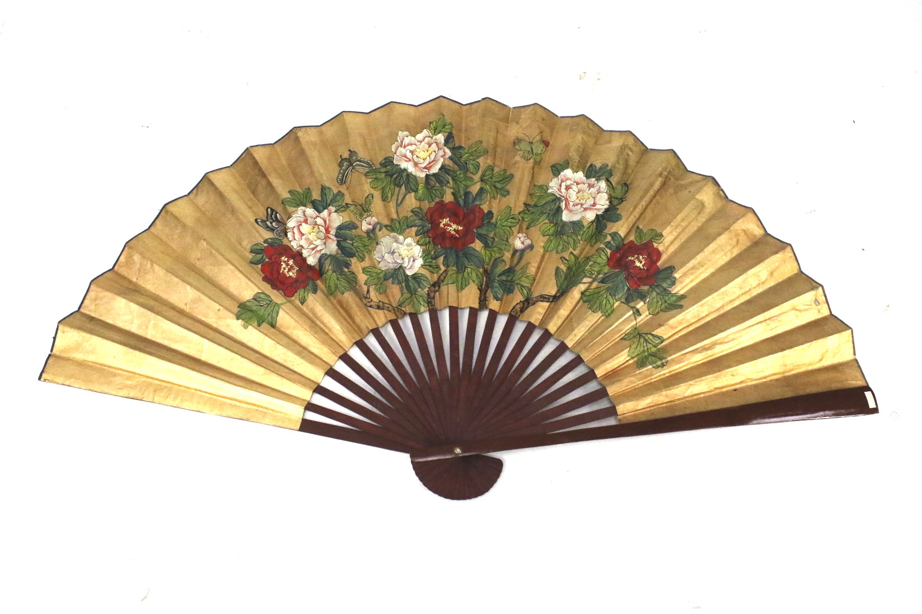A large contemporary Chinese fan. With red lacquer struts and floral decoration on paper. 89cm long.