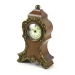 A small mahogany mantel clock.