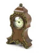 A small mahogany mantel clock.