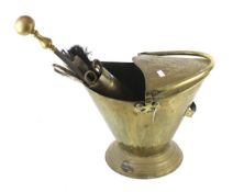 A brass fire side companion set. Including a coal scuttle and tools in a shell case.