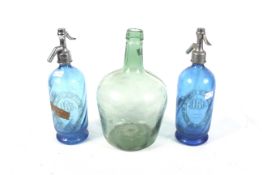 Two blue glass soda syphons and a green glass bottle Condition Report: All appear