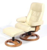 A swivel easy recliner lounge armchair and matching footstool.