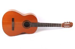 A Spanish Malaga BM machine made guitar. L99.5cm, with associated zip case.