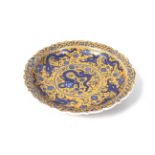 A 20th century Chinese dish. Printed with blue dragons on a yellow ground, Diameter 31.