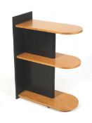 An Art Deco style freestanding shelf unit. Black and maple with three shelves.
