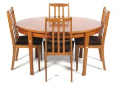 A mid-century teak extendable oval table and four chairs.