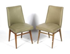 A pair of mid-century vinyl office chairs. Light green upholstery, on turned tapering supports.