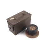 A military compass mounted on a wooden base and and an H83MK2 ammunitions box.