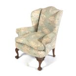 An early 20th century upholstered George I style upholstered wingback chair.