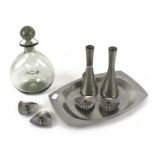 A selection of Scandinavian stainless steel items and a glass decanter.