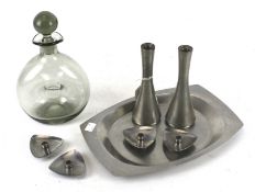 A selection of Scandinavian stainless steel items and a glass decanter.