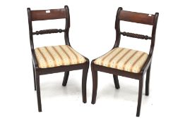 A pair of Regency style mahogany bar back dining chairs. With rope stretcher with drop in seats.