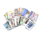 An assortment of Brooke Bond trading card albums and postcards.