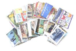 An assortment of Brooke Bond trading card albums and postcards.