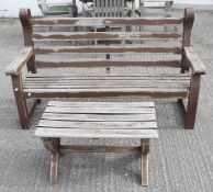 A traditional wooden garden bench and coffee table.