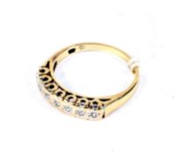 A modern 9ct gold and diamond seven stone ring. The round brilliants, circa 0.