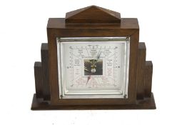 An Art Deco style oak cased mantel or wall hanging aneroid barometer. H16.