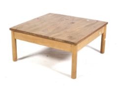 A mid-century Ercol '602' label square coffee table. On turned supports.