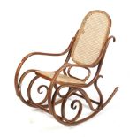 A mid-century bentwood and rattan rocking chair.