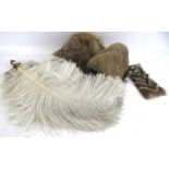 A vintage fur hat, an ostrich feather fan, fur collar and faux fur muff.