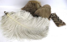 A vintage fur hat, an ostrich feather fan, fur collar and faux fur muff.