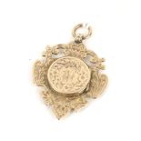 An Edwardian 9ct rose gold sporting fob medallion/locket.