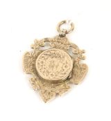 An Edwardian 9ct rose gold sporting fob medallion/locket.