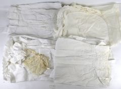 A collection of vintage cotton christening gowns and children's clothes, etc.