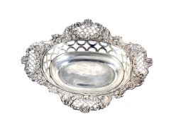 An Edwardian silver shaped-oval, pierced and floral embossed sweet dish.