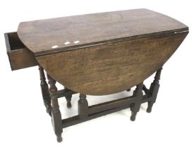 An oak oval gateleg dining table.